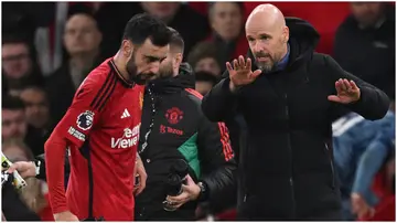 Erik ten Hag speaks with Bruno Fernandes during the Premier League football match between Manchester United and Aston Villa at Old Trafford. Photo by Oli Scarff.