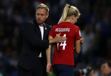 Norway head coach Martin Sjogren consoles striker Ada Hegerberg after their 8-0 Euro 2022 defeat to England in Brighton