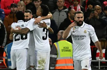 Karim Benzema (2L) celebrates scoring his Real Madrid's fourth goal in the Liverpool win