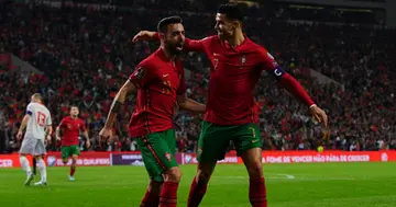 Bruno Fernandes celebrates with teammate Cristiano Ronaldo after scoring a goal during the 2022 FIFA World Cup Play-Off match between Portugal and North Macedonia. Photo by Gualter Fatia.