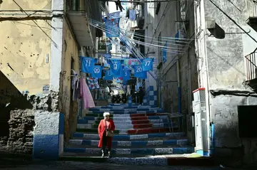 (FILES) In this file photo taken on March 24, 2023 Flags and banners decorate the Quartieri Spagnoli district on March 24, 2023 in Naples, as the city braces up for its potential first Scudetto championship win in 33 years. From narrow streets to balconies, the whole city of Naples is tinged with blue, the colour of its football club which is about to win the Scudetto for the first time since 1990, then with Diego Maradona, who is still revered as a saint today.