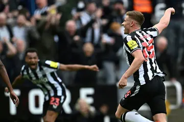 Newcastle's Harvey Barnes (R) celebrates after scoring against West Ham