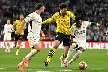 Mats Hummels (centre) with Real Madrid's goalscorers  Vinicius Junior (right) and Dani Carvajal