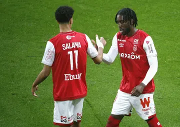 Josh Wilson-Esbrand (R) celebrates with teammate Amine Salama after scoring for Reims against Lorient