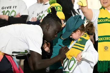 Australia's Awer Mabil signs an autograph