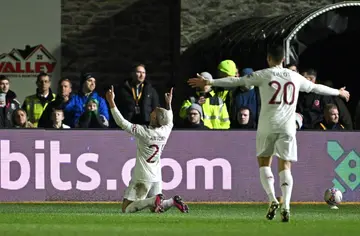 Manchester United's Antony (L) celebrates scoring against Newport