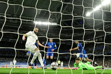 Karim Benzema (L) scores his team's first goal against Chelsea in their comfortable win