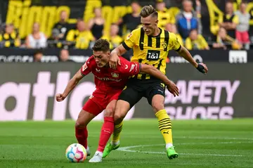 Hard man: Nico Schlotterbeck (right) showed his toughness against Patrik Schick and Leverkusen as Dortmund won their season opener