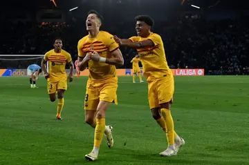 Robert Lewandowski celebrates with Lamine Yamal as Barcelona snatched a 2-1 win at Celta Vigo on Saturday