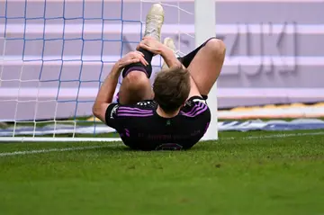 Bayern Munich forward Harry Kane holds his leg during Saturday's 5-2 win at Darmstadt.