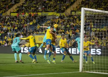 Leap of faith: Barcelona forward Robert Lewandowski (centre) jumps for the ball with Las Palmas defender Sergi Cardona