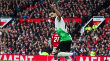Mohamed Salah celebrates scoring his side's second goal from the penalty spot during the Premier League match between Manchester United and Liverpool FC at Old Trafford. Photo by Alex Dodd.