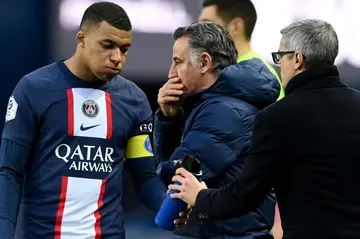 Paris Saint-Germain coach Christophe Galtier (C) with Kylian Mbappe during a Ligue 1 game last month