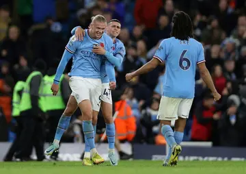 Manchester City striker Erling Haaland (L) celebrates scoring against Fulham