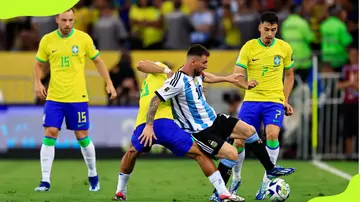 Argentina's Lionel Messi (no.10) battles for the ball with André of Brazil 