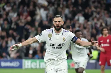 Real Madrid forward Karim Benzema celebrates scoring against Liverpool and sealing his team's place in the quarter-finals
