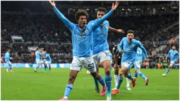 Oscar Bobb celebrates with Rodri during the Premier League match between Newcastle United and Manchester City. Photo by Simon Stacpoole.