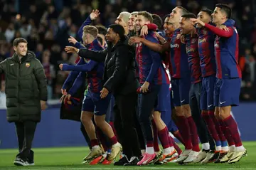 Barcelona players celebrate clinching a Champions League quarter-final spot in midweek