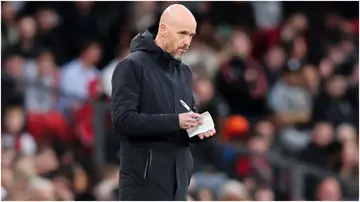 Erik ten Hag writes notes during the Premier League match between Manchester United and Sheffield United at Old Trafford. Photo by Matt McNulty.