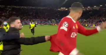 Cristiano Ronaldo was grabbed by a pitch invader after inspiring Manchester United to a stunning comeback win. Photo: Virgin Media Sport.