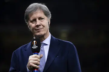 Fulvio Collovati holds a microphone prior to the UEFA Europa League quarter-final first leg football match between AC Milan and AS Roma. AS Roma won 1-0 over AC Milan. Photo: Nicolò Campo/LightRocket