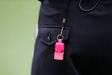 An official using a pink whistle