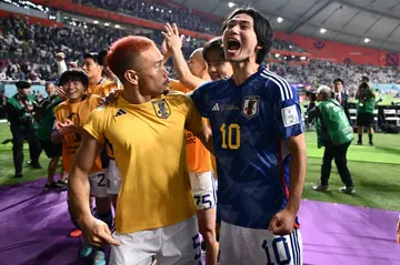 Japan's Yuto Nagatomo (left)and Takumi Minamino celebrate after their side's World Cup win against Germany