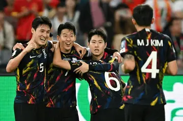 Son Heung-min (2L) and his South Korean team-mates celebrate scoring against China