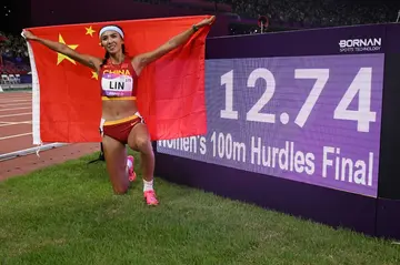 China's Lin Yuwei celebrates winning the women's 100m hurdles