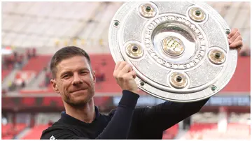 Bayer Leverkusen coach, Xabi Alonso, celebrates with the Bundesliga 'Meisterschale' trophy after his team's victory over FC Augsburg at BayArena on May 18, 2024.
