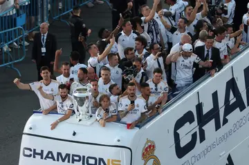 Real Madrid players parade the Champions League trophy on an open top bus after they won it for the 15th time at Wembley on Saturday