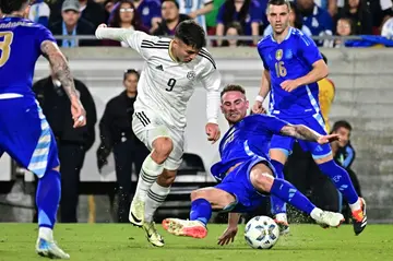 Argentina midfielder Alexis Mac Allister slides in to tackle Costa Rica forward Manfred Ugalde in their friendly win in Los Angeles on Tuesday