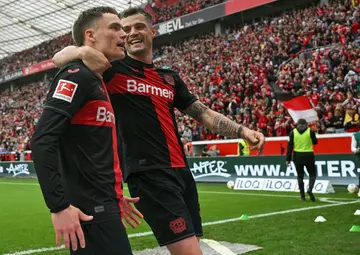 Florian Wirtz (L) and Granit Xhaka (R) will be staying with new Bundesliga champions Bayer Leverkusen next season