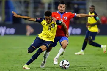 Ecuador's Byron Castillo (L) holds off Chile's Jean Meneses in a qualifying match in Santiago in 2021. Ecuador won, 2-0. Chile complained that Castillo was not Ecuadorean
