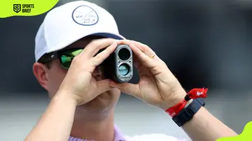 A caddie looks through a finder