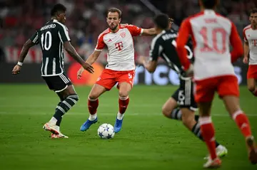 Englishmen abroad: Manchester United's Marcus Rashford (left) challenges Bayern Munich's Harry Kane