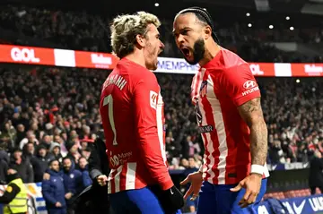 Atletico Madrid's Dutch forward Memphis Depay (R) celebrates scoring in the win over Rayo Vallecano which sent his team third in La Liga