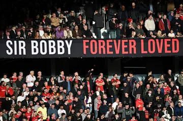 A banner for United legend Bobby Charlton is displayed at Old Trafford