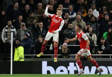 Arsenal midfielder Martin Odegaard (C) celebrates scoring at Tottenham
