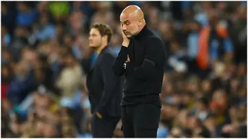 Manchester City manager, Pep Guardiola, looks dejected during a UEFA Champions League match at the Etihad Stadium.