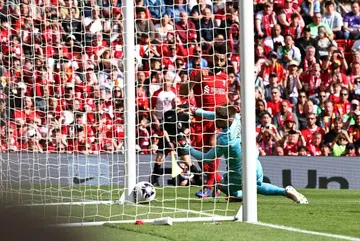 Mohamed Salah (L) scores for Liverpool against Tottenham Hotspur at Anfield.