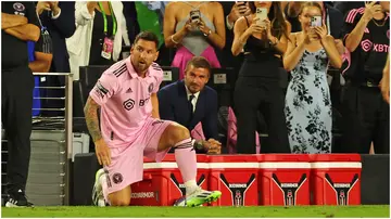 Lionel Messi on the touchline before making his Inter Miami debut against Cruz Azul, with David Beckham watching from the sidelines..