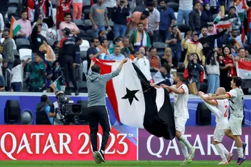 Syria's players celebrate reaching the last 16