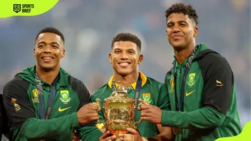 Grant Williams, Kurt-Lee Arendse, and Canan Moodie hold a cup