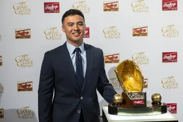 Anthony Volpe posing with the Rawlings Gold Glove Award