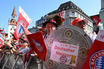 Bayern Munich fans celebrate winning the men's and women's titles at the city's Marienplatz square on Sunday
