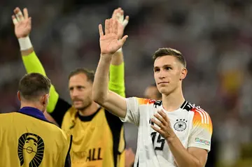 Nico Schlotterbeck waves to fans after Germany beat Denmark in Euro 2024
