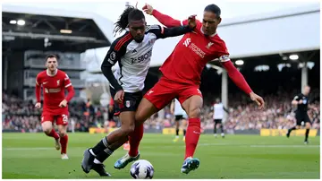 Fulham's Alex Iwobi battles for possession with Liverpool's Virgil van Dijk during the Premier League clash at Craven Cottage on April 21. Photo: Justin Setterfield.