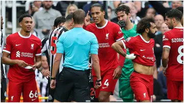 Referee John Brooks sends off Virgil van Dijk during the Premier League match between Newcastle United and Liverpool FC at St. James Park. Photo by Matthew Ashton.