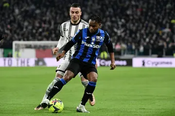 Atalanta midfielder Ademola Lookman (R) shields the ball during a Serie A match against Juventus.